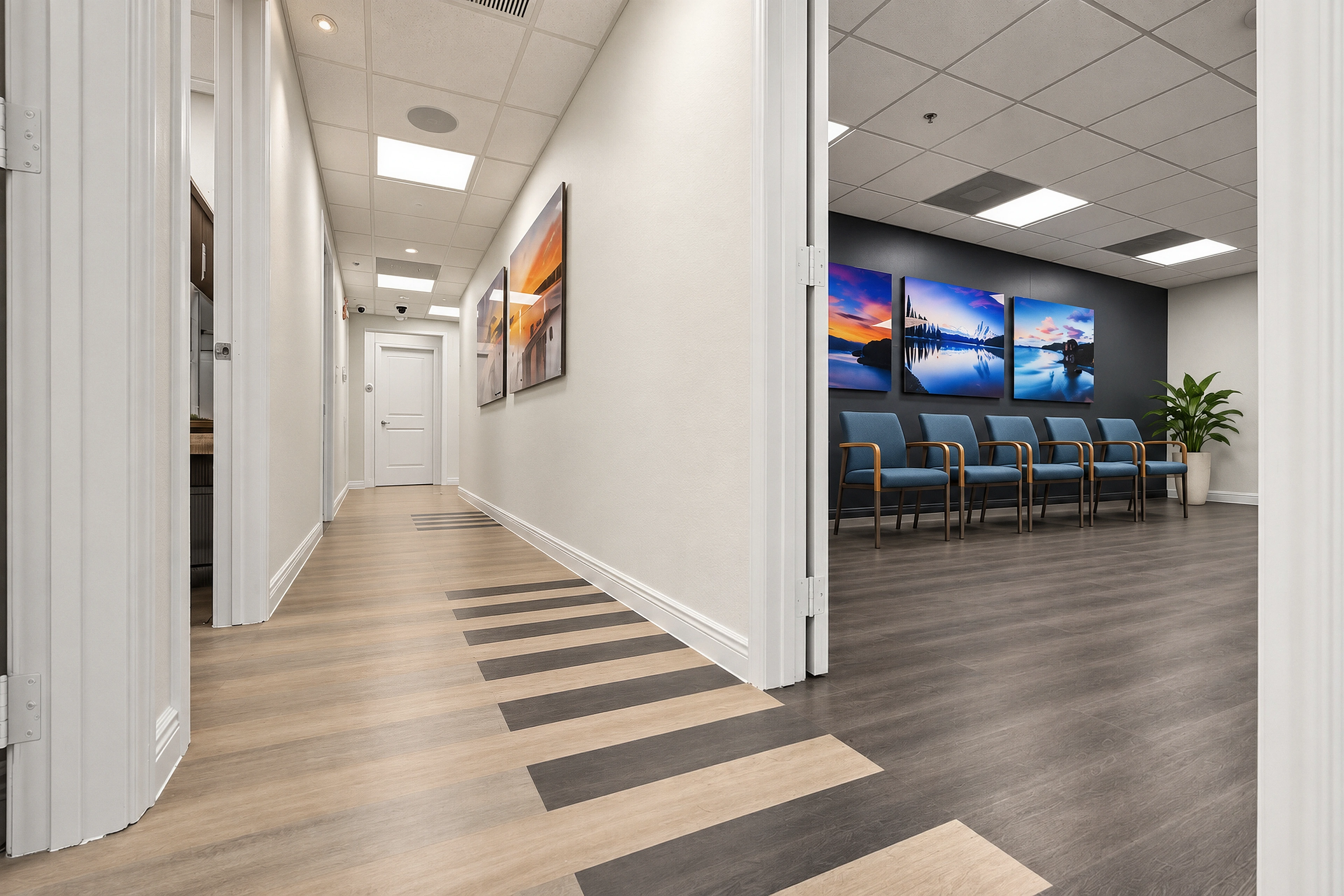 The hallway connecting blue waiting-room seating with private treatment rooms.