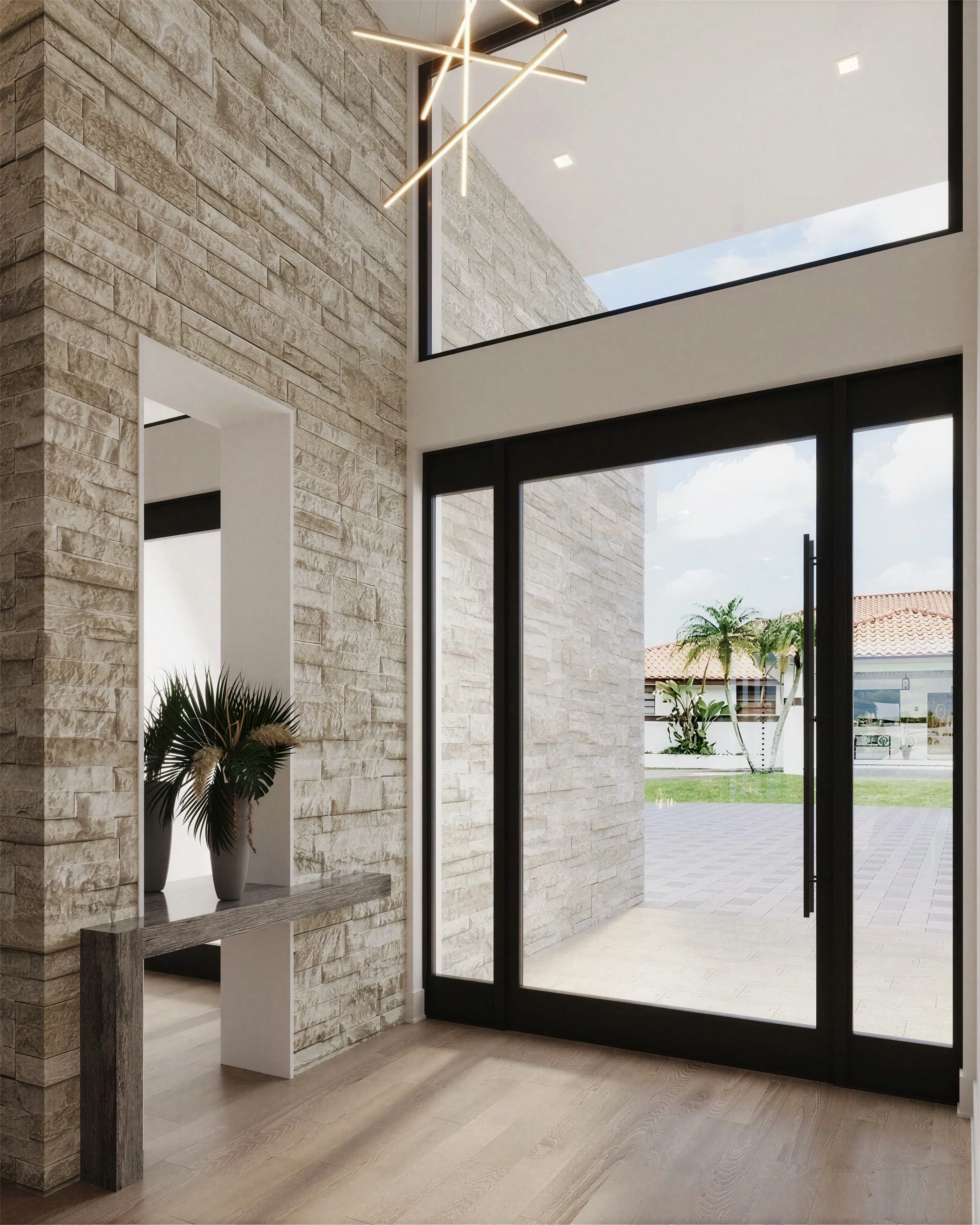 Entry with tall glazing and a textured accent wall.