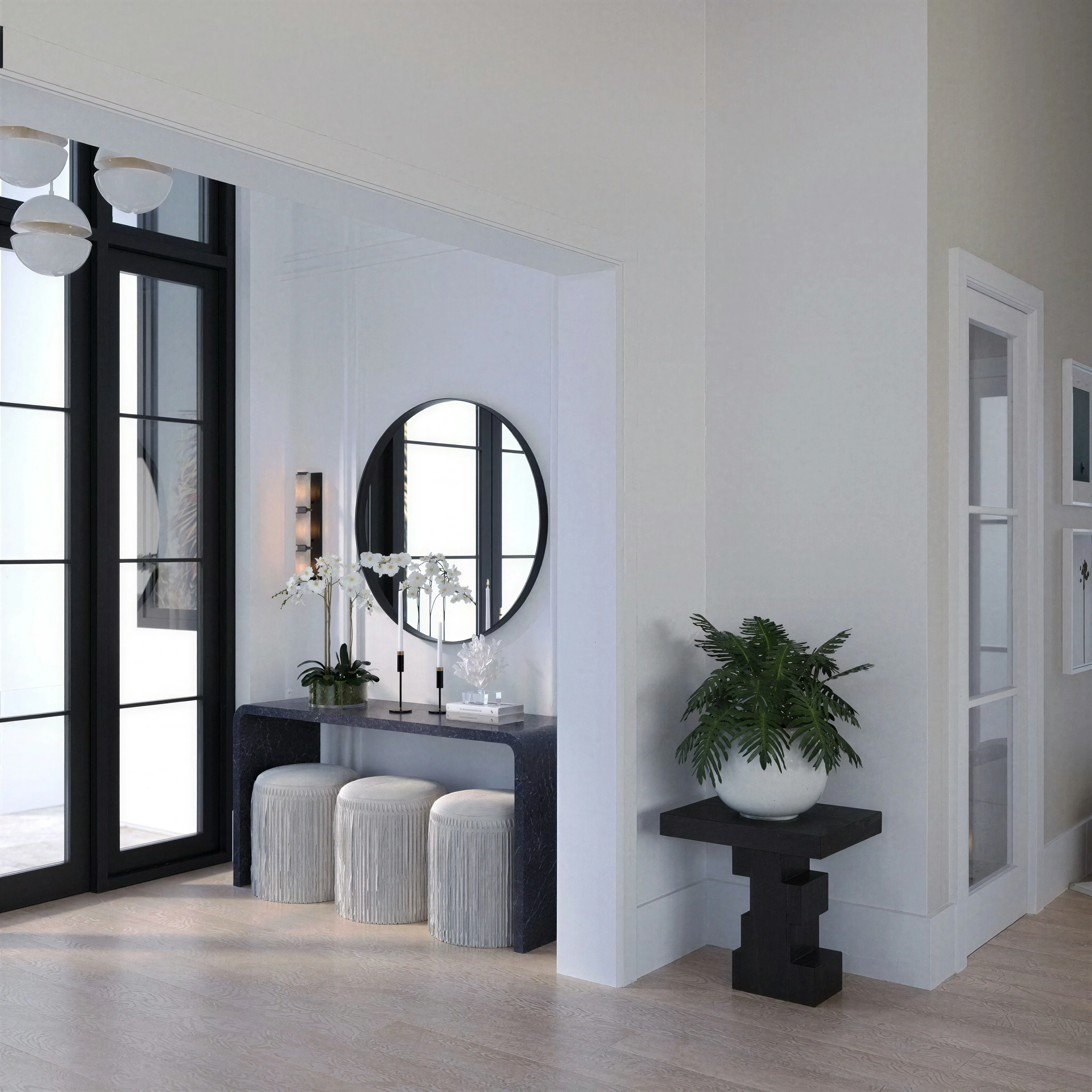 Entry console beneath a round mirror.