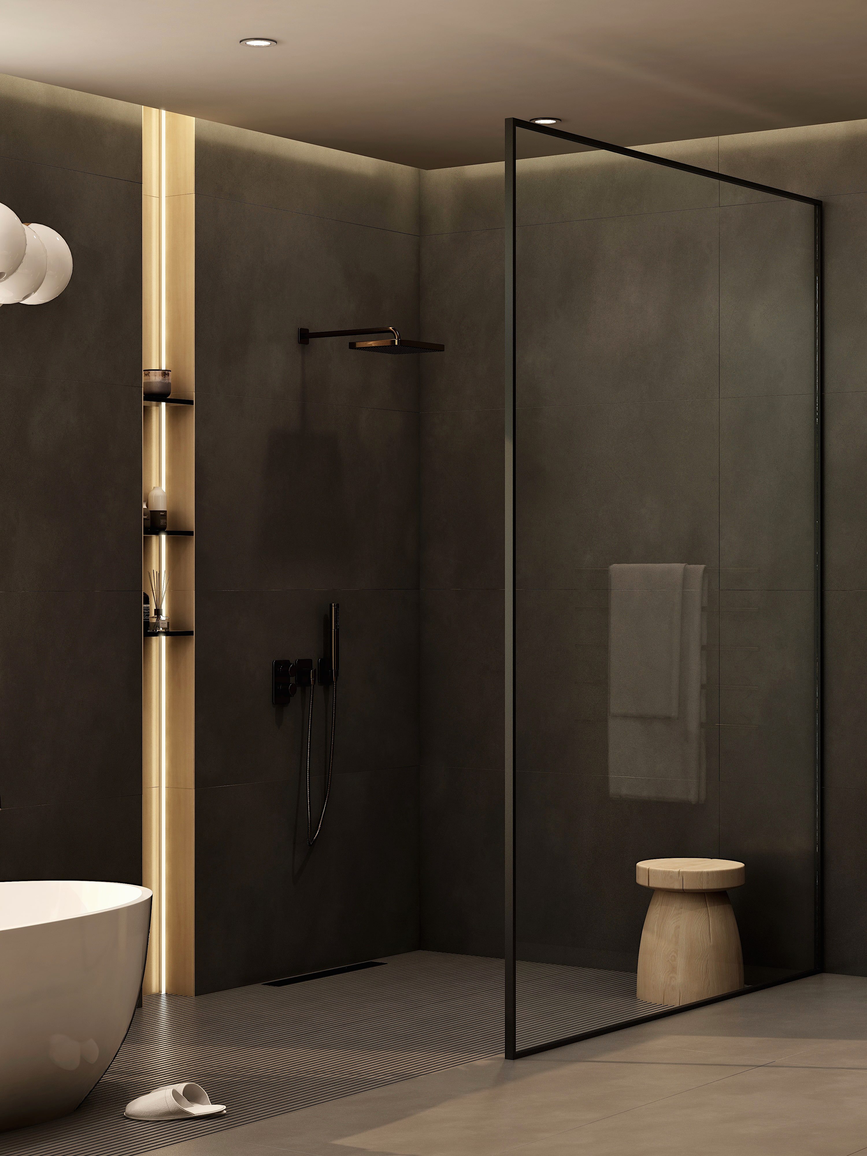 Dark tiled shower enclosure with a clear glass door.