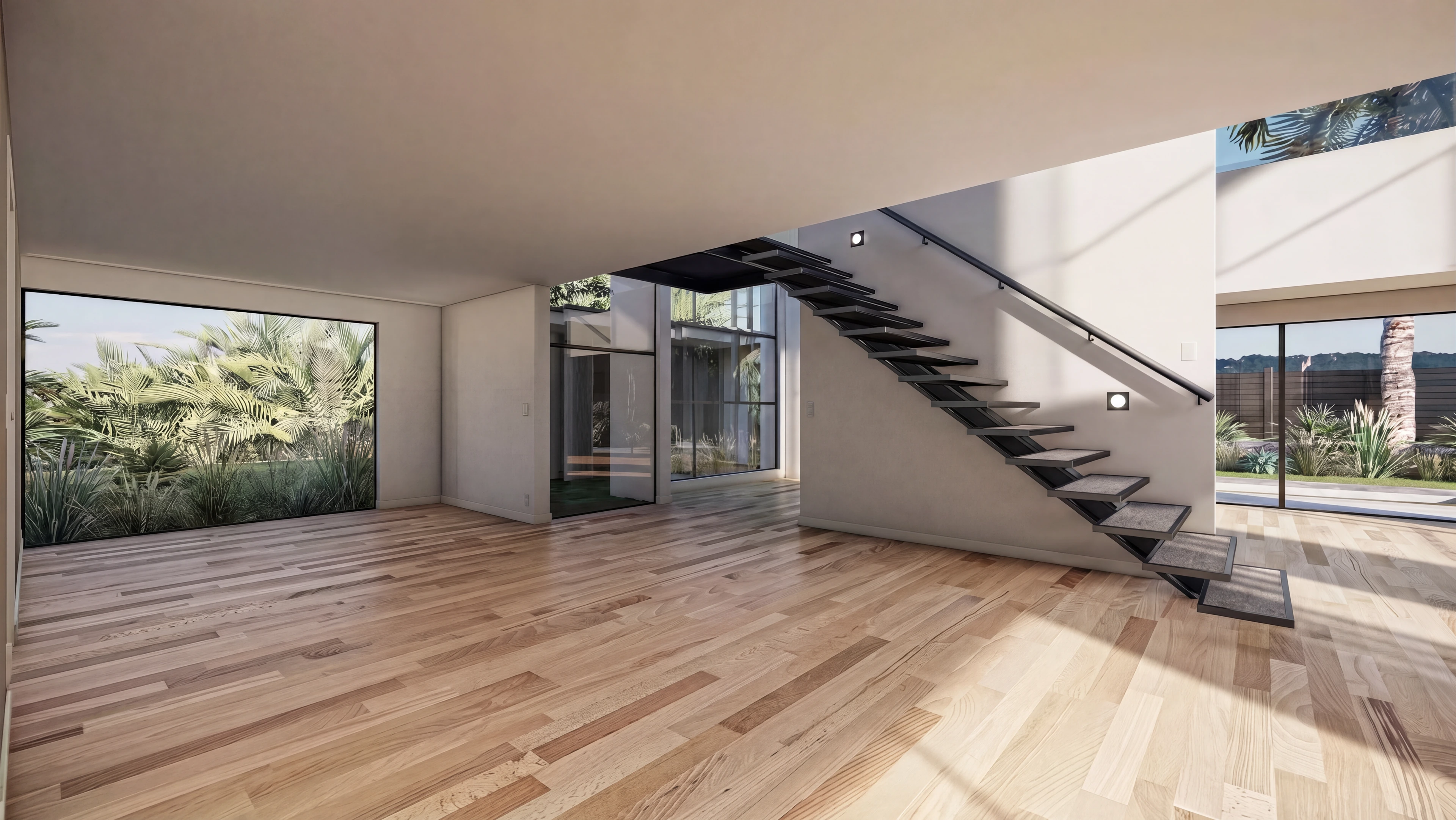 Open interior with wood flooring and a floating staircase.