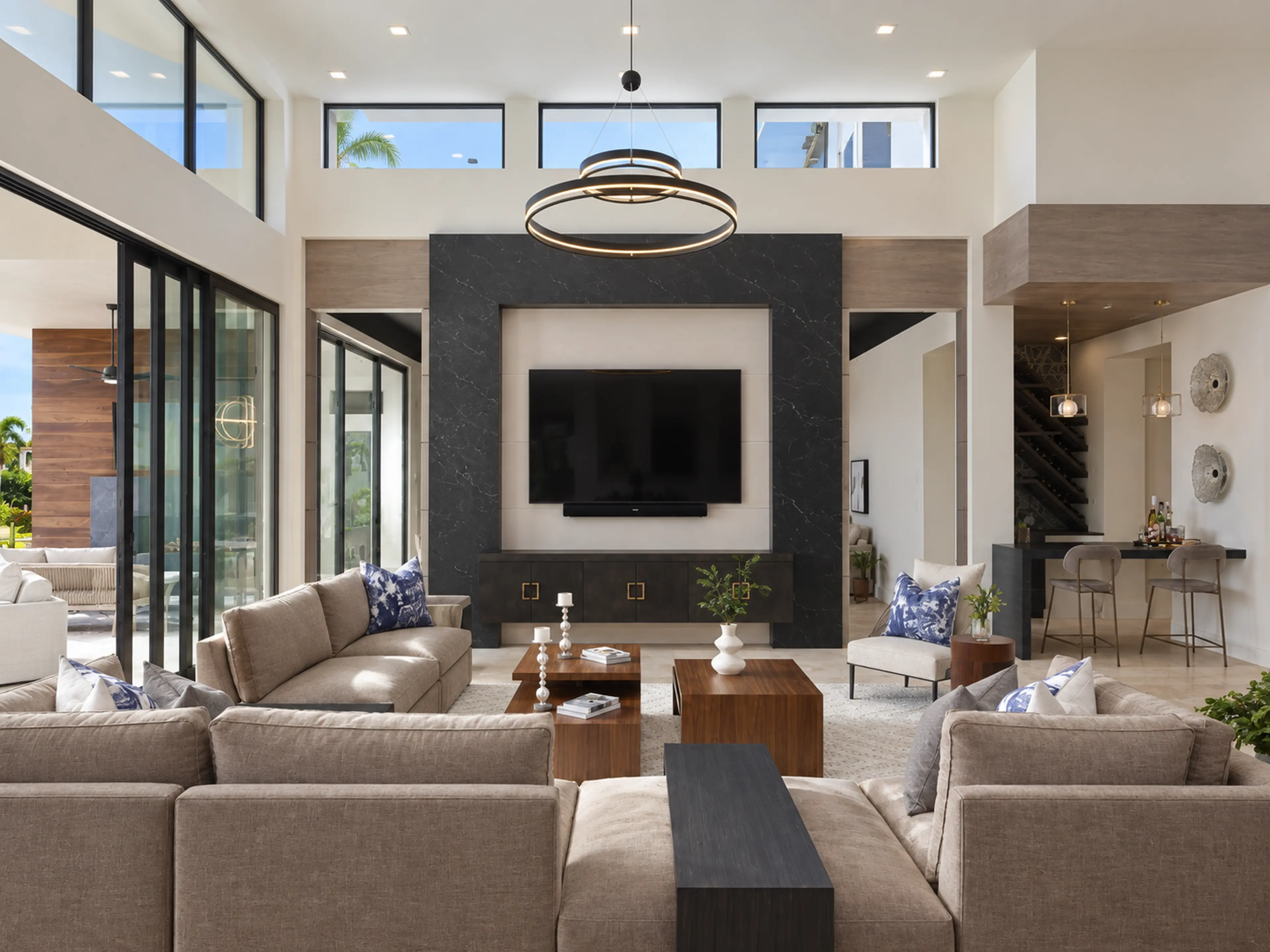 Reverse living-room view with a dark media wall and clerestory windows.